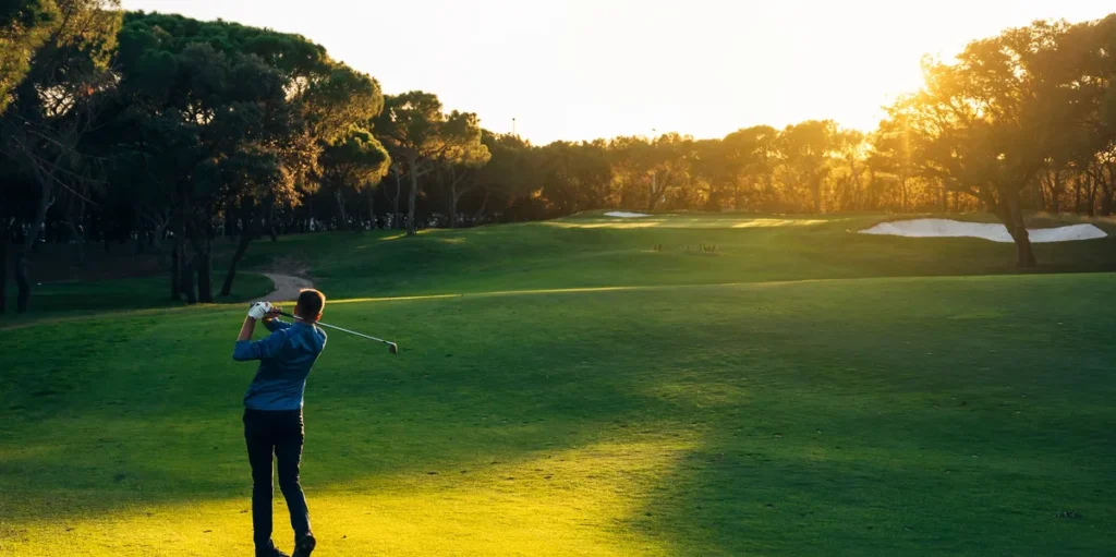 Man in fairway hitting a golf shot